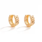 Diahann Diamond textured huggie earrings in gold.